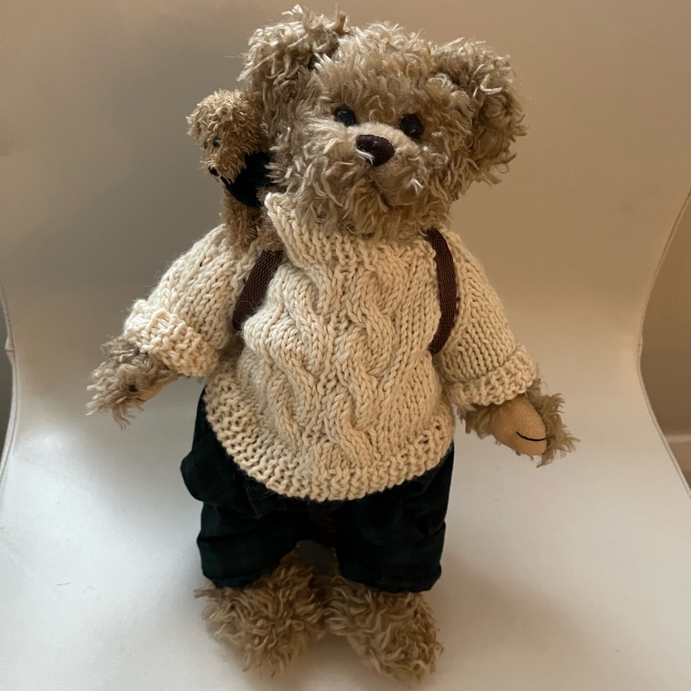 Bearington Bear collectible, baby in backpack, and stand holder